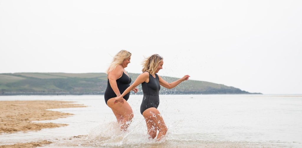 Two women play in the sea for atlantic blankets 5 top tips for cold water swimming