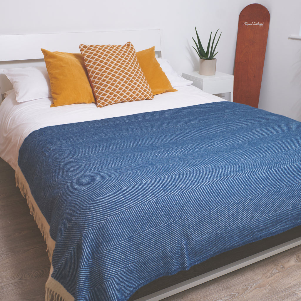 large navy wool blanket across a king size bed