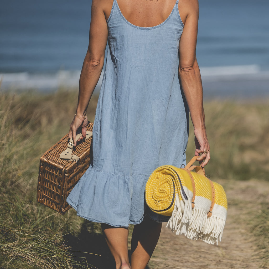 Yellow picnic blanket by Atlantic Blankets, rolled with leather straps